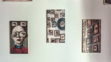 A wall with three artworks.