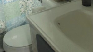 A bathroom with a toilet, a sink, and a bathtub.