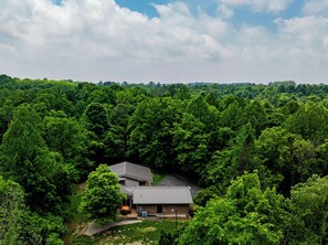 A house surrounded by dense forest.