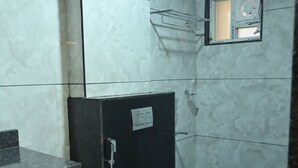 A small bathroom with a toilet, a shower, and a sink. - Kamath Yatri Nivas Plus (Bhatkal)
