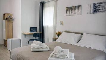 Desk, laptop workspace, blackout drapes, iron/ironing board