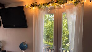 A room with a wooden bench, a globe, and a TV mounted on the wall. - Quiet retreat near the interchange with woodland views. (Patchway)
