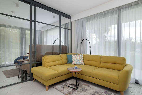Relax in the stylish living room with a comfortable sofa and modern decor.