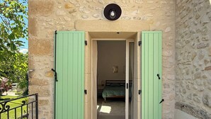 A stone building with a wooden deck and green shutters. - ⭐​ The Colibris Loft ⭐​ (Mirabel-et-Blacons)