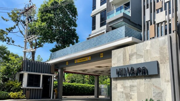 A modern building entrance with a sign indicating '2 PM Clearance.' - Mountain View Condo by Bang Tao Beach-MynaC289 (ตำบลเชิงทะเล)