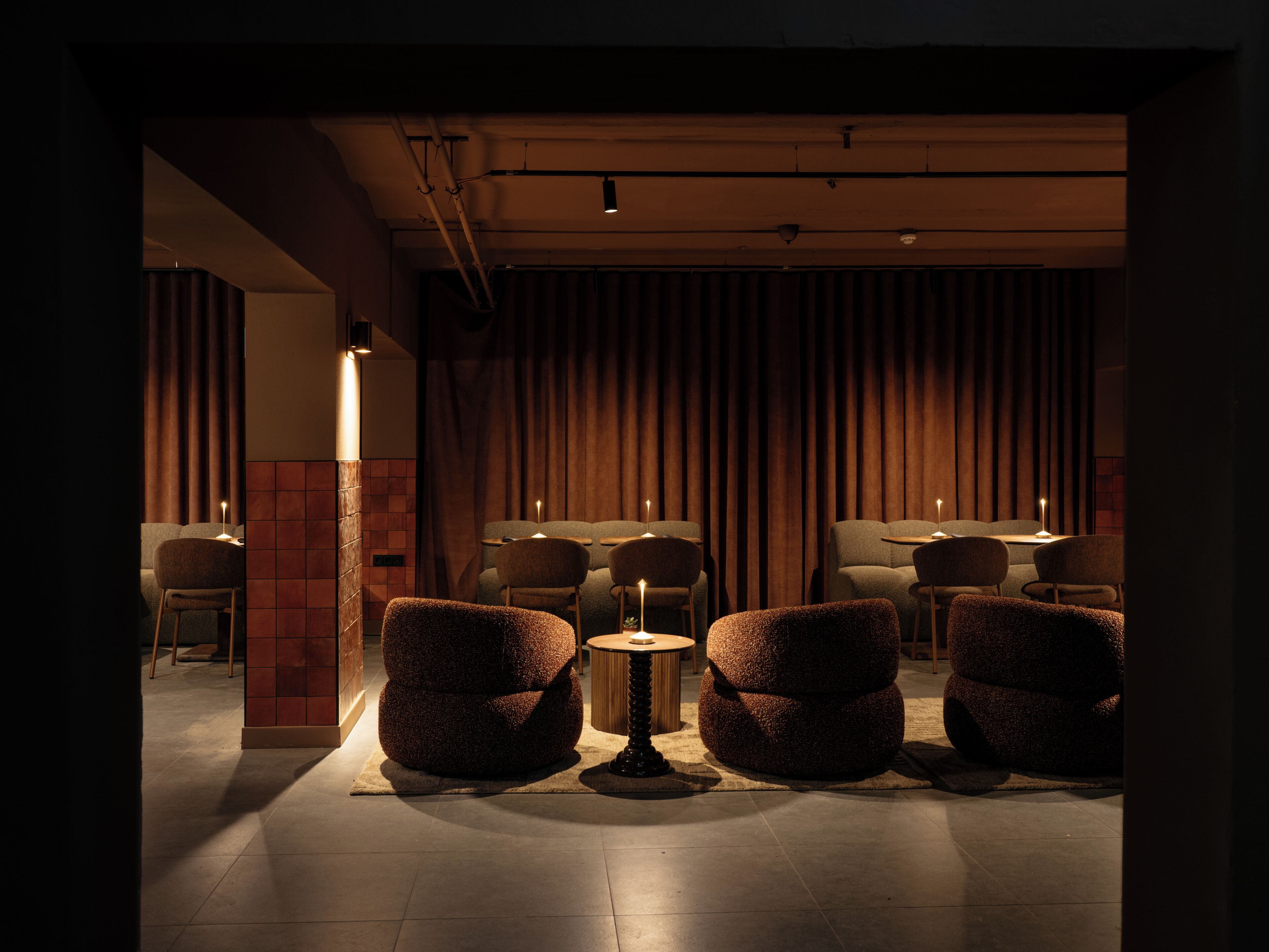 Un salón tenuemente iluminado con asientos cómodos e iluminación ambiental.