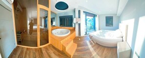 A modern bathroom with a wooden vanity, a large bathtub, and a glass-enclosed shower area. - Peaceful Holiday Villas-luxury (Serik)