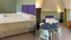 Ein Hotelzimmer mit zwei Betten, einem Esstisch mit Stühlen und einer Steinwand.