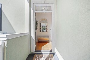 A hallway leading to a room with a bench, a door with a doormat, and a window with a view. - WINTER RENTER AMENITIES INCLUDED 4 bdr Elevator 8500 monthly Seabrook Charleston (Seabrook Island)