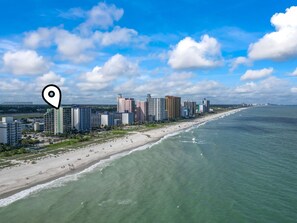 A coastal cityscape with high-rise buildings, a beach, and a clear sky. - The Ocean Escape | Prime Myrtle Beach Getaway (Myrtle Beach)