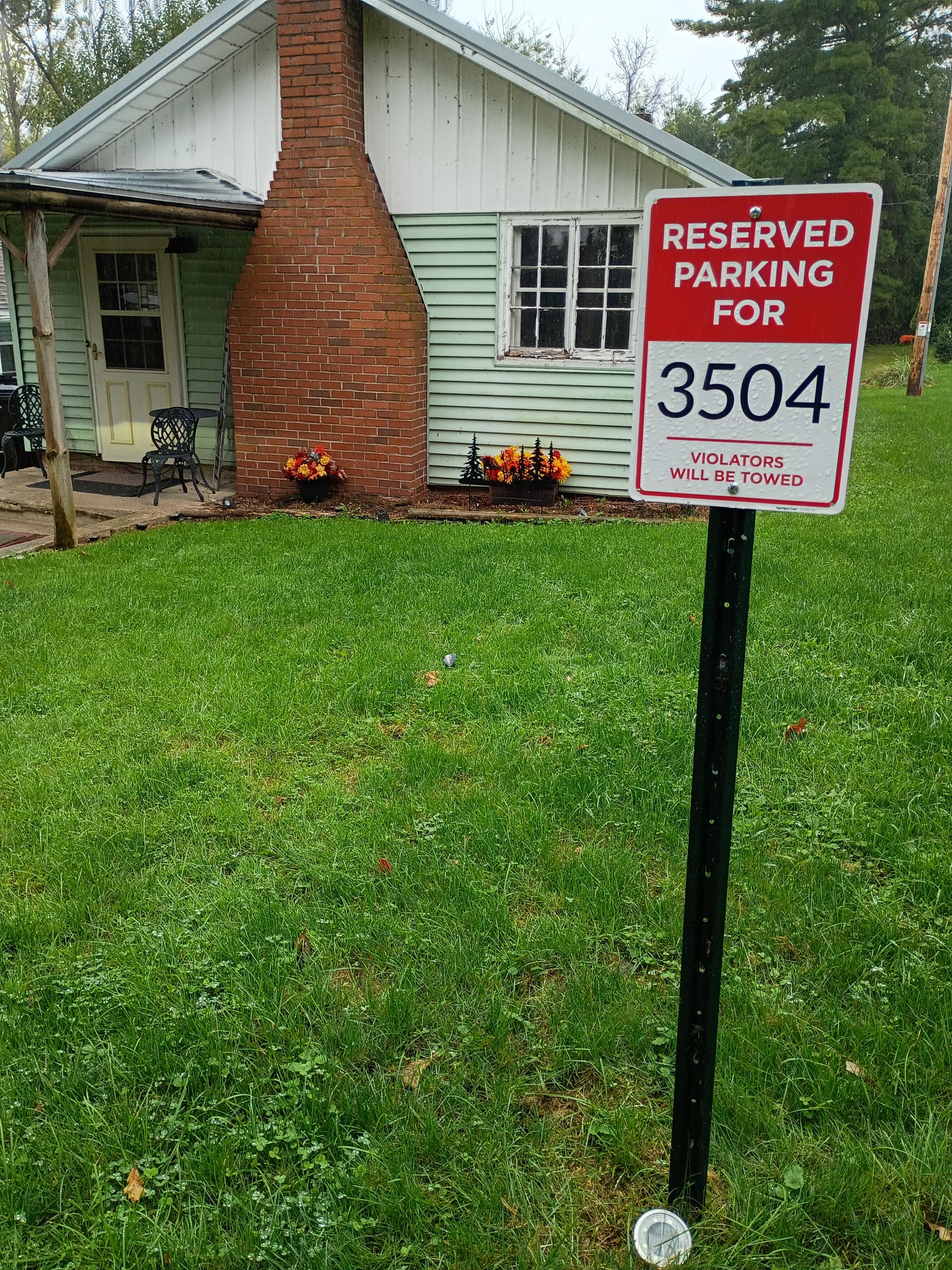 A sign indicating reserved parking for a specific number.