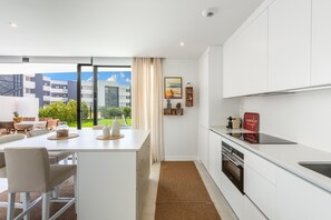 Una cocina moderna con una isla grande, un comedor con vistas y una kitchenette.