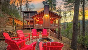 A cabin with a deck, outdoor seating, and a fire pit. - Grounding Lodge | Sauna + Cold Plunge + Hot Tub (Blue Ridge)