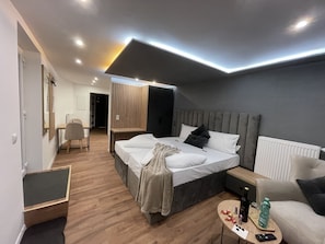 A modern bedroom with a bed, bedside table, and a chair.