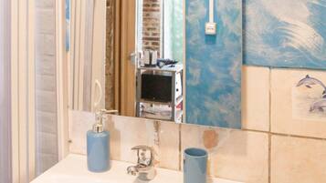 A bathroom with a sink, mirror, and a towel rack.
