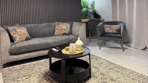 A modern living room with a grey sofa, a round coffee table, and a black floor lamp. - RHODESIA guest house
Sea view apartment
Pet friendly
2’  beach (Chalkida)
