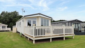 A mobile home with a deck, a fenced porch, and a satellite dish. - Finch 66 (Scarborough)