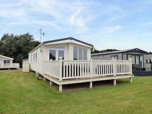 A mobile home with a deck, a fenced porch, and a satellite dish. - Finch 66 (Scarborough)