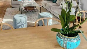 A modern living room with a sofa, chairs, a coffee table, and a decorative vase with flowers. - Estate with olive grove near Grimaud (Cogolin)