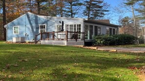 A single-story house with a porch, a small deck, and a front yard. - Coastal Hideaway Retreat (York)