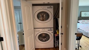 A laundry room with two stacked front-loading washing machines. - Beautiful Townhouse close to both Short Sands and. (York)