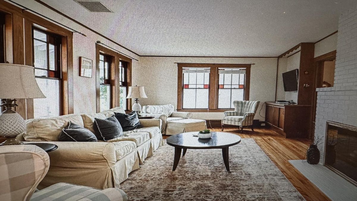A living room with a sofa set, a coffee table, and a fireplace.