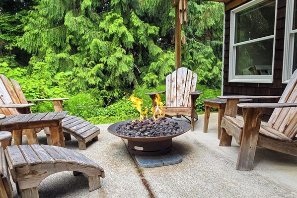 An outdoor seating area with Adirondack chairs and a fire pit. - Private forest escape with creekside trails and firepit (Port Angeles)