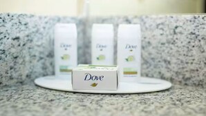 A countertop with Dove products, including a box and two bottles.