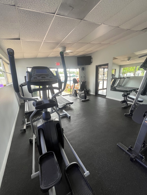 A gym with treadmills, elliptical machines, and weight equipment.