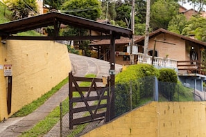 A residential building with a gated entrance, a small porch, and a sign indicating a 3-star rating.
