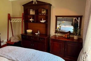 A bedroom with a bed, a wooden dresser, a mirror, and a wardrobe. - Luxury Private Apartment Sleeps 4, Free Parking (Bective)