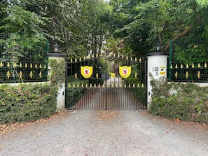 A gated entrance with a cobblestone path leading through.