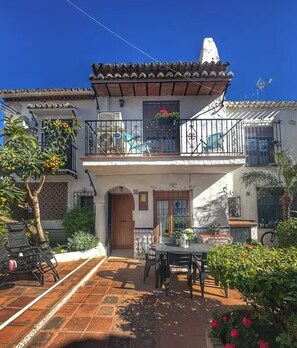 A two-story house with a tiled roof, a balcony with a railing, and a door marked with the number 35. - House Sleeps 4 With Pool and Parking (Nerja)