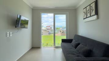 Standard Apartment, Sea View | Living area | 32-inch Smart TV with digital channels
