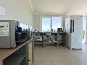 A modern kitchen with a microwave, toaster, and refrigerator.