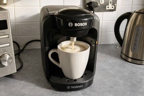 A coffee machine with a cup underneath, connected to a power outlet. - City Centre | Sleeps 6 | Bars, Parking & Netflix (Merseyside)