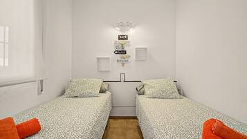 A small, clean room with two single beds, a wall-mounted light, and a sign indicating a cafe.