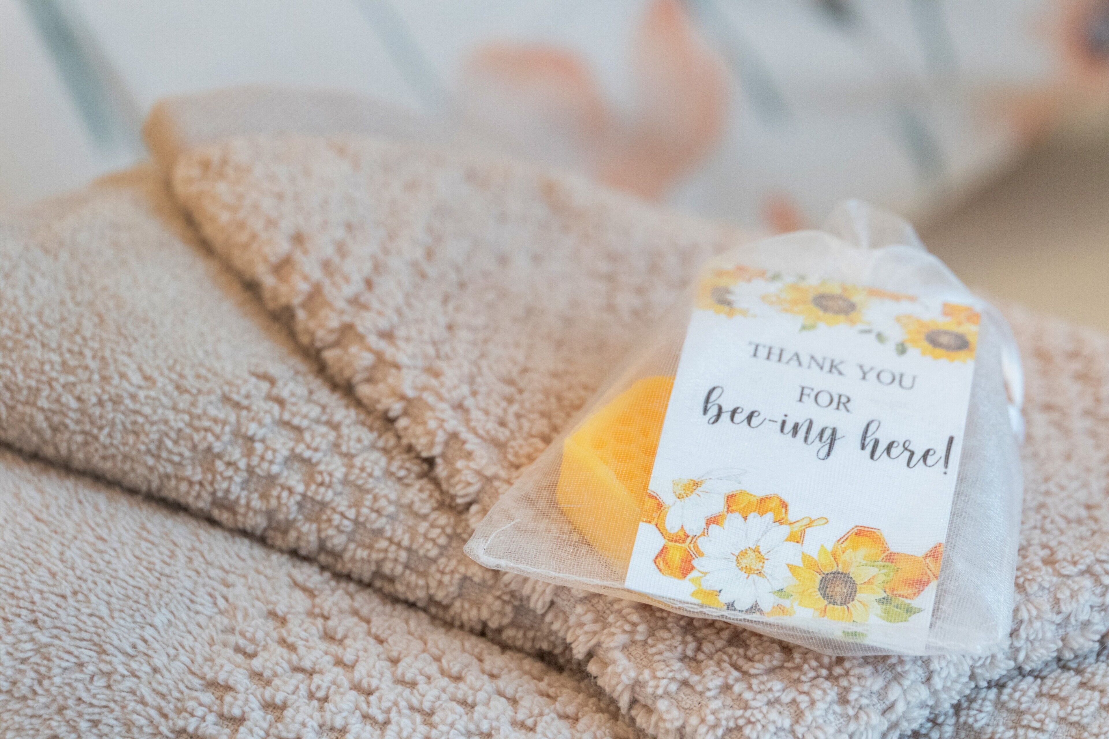 A folded towel with a thank you note attached.