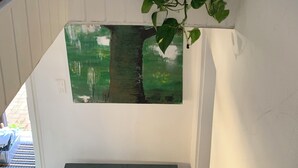 Eine Treppe mit einem Blumentopf, einem Spiegel und einem grünen Wandbild.