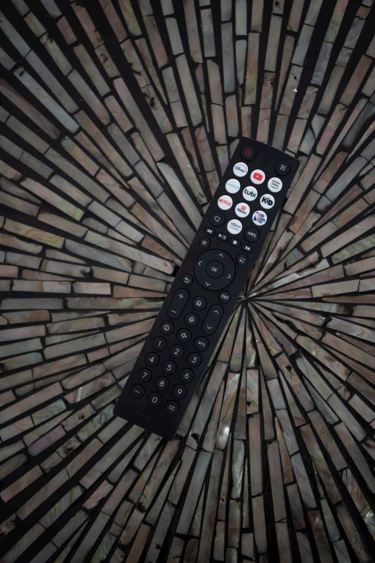 A remote control with various app icons.