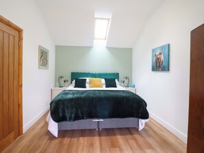 A bedroom with a bed, a window, a door, and a painting. - Henlle Home Farm (Oswestry)