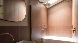 A modern bathroom with a large mirror, a rectangular sink, and a shower area. - Hertfordshire Cottage, Designer, with Barn Suite (Wandon Green)