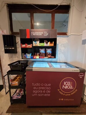 An ice cream stand with a sign that reads 'ICE by NICE' and a freezer in the foreground. - Spacious flat in Copacabana (Rio de Janeiro)