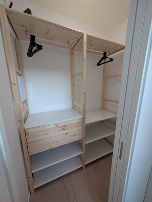 A wooden wardrobe with open shelves and a flat storage area. - The perfect way to experience Milan in total comfort (Milano)