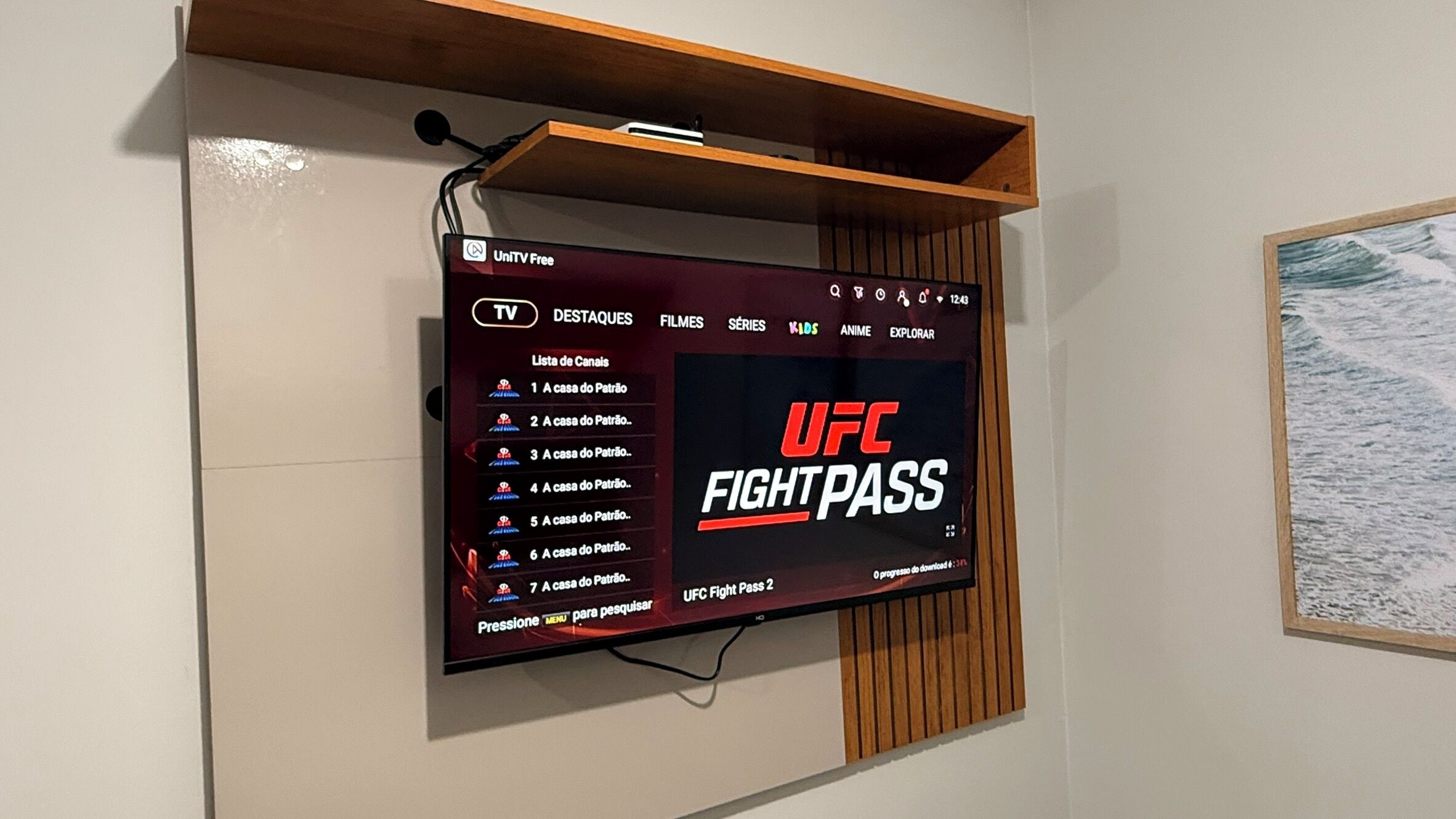 A TV mounted on a wall displaying a UFC Fight Pass menu.