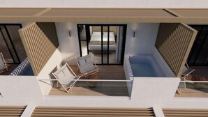 A modern building with a balcony, a bed, and two chairs. - Nerion Hotel & Spa (Chania)