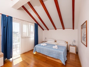 A bedroom with a bed, nightstands, a window with curtains, and a wooden ceiling. - Villa Seka Mlini (Zupa dubrovacka)