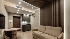 Un interior moderno con comedor, kitchenette y sofá.