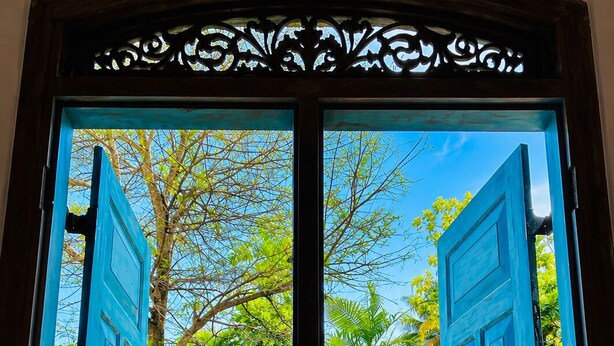 A double door with a view of a lush garden. - this is turtle paradise, Bentota Sri Lanka (Kosgoda)