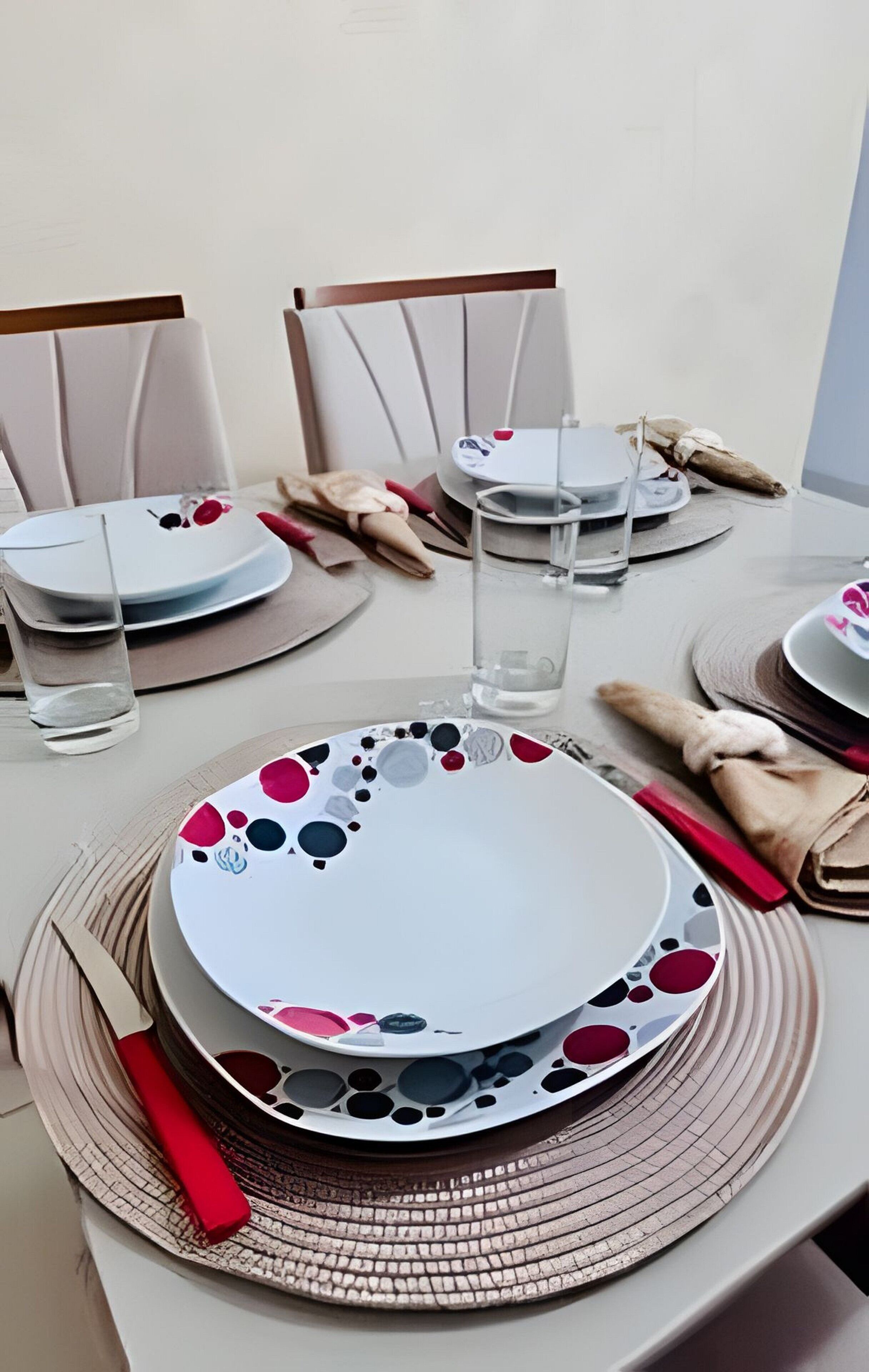 A table set with plates, glasses, and cutlery, indicating a dining arrangement.